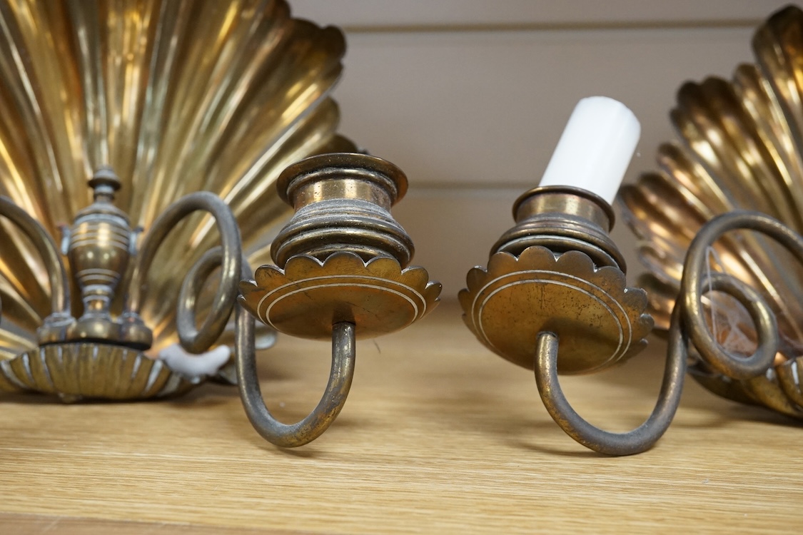 A pair of brass twin branch wall lights with scallop shell backs, 26cm high